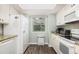 Bright kitchen with white cabinets, granite countertops, and modern appliances offers functional space at 410 Yacht Harbor Ct # 410, Isle of Palms, SC 29451