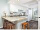 Cozy kitchen with granite countertops, breakfast bar, and stainless steel appliances at 410 Yacht Harbor Ct # 410, Isle of Palms, SC 29451
