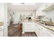 Well-lit kitchen with granite countertops and white cabinets, open to the living space at 410 Yacht Harbor Ct # 410, Isle of Palms, SC 29451