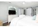 Comfortable main bedroom featuring a white dresser, TV, and a glimpse into the en-suite bathroom at 410 Yacht Harbor Ct # 410, Isle of Palms, SC 29451