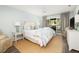 Cozy main bedroom with sliding doors to a deck, complemented by a decorative bed and stylish furniture at 410 Yacht Harbor Ct # 410, Isle of Palms, SC 29451