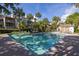 Beautiful community pool view on a bright day with tropical landscaping surrounding resort style living at 410 Yacht Harbor Ct # 410, Isle of Palms, SC 29451