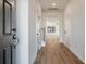 Inviting hallway with wood floors leading to a bright living space and staircase at 420 Duskywing Dr, Goose Creek, SC 29445