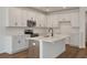 Modern kitchen boasts white cabinets, subway tile backsplash, and center island with sink at 420 Duskywing Dr, Goose Creek, SC 29445