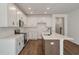 Well-lit kitchen with quartz counters, stainless steel appliances, and modern cabinets at 420 Duskywing Dr, Goose Creek, SC 29445