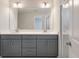 Bathroom featuring a double sink vanity and a walk-in shower with glass enclosure at 422 Duskywing Dr, Goose Creek, SC 29445