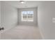Empty bedroom features neutral carpet, one window, and light walls at 422 Duskywing Dr, Goose Creek, SC 29445