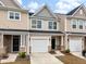 Townhome exterior with neutral color scheme, one-car garage, and manicured landscaping at 422 Duskywing Dr, Goose Creek, SC 29445