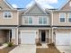 Charming townhome with attached garage, stone accents, and neutral siding provides excellent curb appeal at 422 Duskywing Dr, Goose Creek, SC 29445