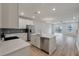 Modern kitchen with stainless appliances, white cabinets, and a center island open to the living area at 422 Duskywing Dr, Goose Creek, SC 29445