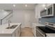 Modern kitchen featuring stainless appliances, white cabinets, quartz countertop, and a stylish blue backsplash at 422 Duskywing Dr, Goose Creek, SC 29445
