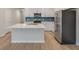 Modern kitchen features quartz countertops, a center island, and stainless steel appliances at 422 Duskywing Dr, Goose Creek, SC 29445
