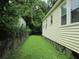 View of the home's backyard and siding of home showing well-manicured lawn and mature landscaping at 47 Oswego St, Charleston, SC 29403