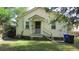 Spacious backyard with lush green grass, mature trees and a covered back porch at 47 Oswego St, Charleston, SC 29403