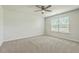 Neutral carpeted bedroom with standard window and ceiling fan at 505 Shady Maple St, Moncks Corner, SC 29461