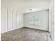 Modern bedroom with wood-look flooring, large window and sliding doors at 505 Shady Maple St, Moncks Corner, SC 29461
