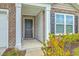 Charming front porch with brick accents, white pillars, and manicured landscaping at 505 Shady Maple St, Moncks Corner, SC 29461