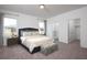 Cozy main bedroom featuring plush carpet, ensuite bath, and walk-in closet for ample storage at 528 Pender Woods Dr, Summerville, SC 29486