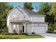 Charming two-story home with white siding, a welcoming front porch, and an attached two-car garage at 535 Verdi Dr, Summerville, SC 29486