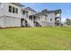 Well-manicured backyard featuring multiple homes, lush lawn, and white staircases at 615 Du Bois Dr, Johns Island, SC 29455