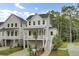 Charming two-story home with white siding, covered porch, and well-manicured landscaping at 615 Du Bois Dr, Johns Island, SC 29455