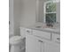 Modern bathroom with white cabinets, sink, toilet and a view of the tub and shower at 617 Du Bois Dr, Johns Island, SC 29455