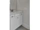 This bathroom features white cabinets and trim with a sink, mirror and neutral walls at 617 Du Bois Dr, Johns Island, SC 29455