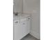This bathroom features white cabinets and trim with a sink, mirror and neutral walls at 617 Du Bois Dr, Johns Island, SC 29455