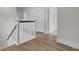 Upper hallway featuring beautiful hardwood floors, white trim, and a view of multiple doorways and rooms at 617 Du Bois Dr, Johns Island, SC 29455
