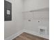 Bright laundry room features wood-look flooring, utility sink, and convenient wire shelving at 617 Du Bois Dr, Johns Island, SC 29455