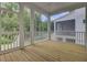 Enjoy outdoor living on this screened porch with wood flooring and white railing at 617 Du Bois Dr, Johns Island, SC 29455