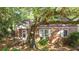 A brick home shaded by a tree and surrounded by greenery, with a small porch at 624 Atlantic St, Mount Pleasant, SC 29464