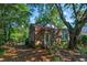 Charming brick home featuring a cozy front porch and mature trees in a wooded yard at 624 Atlantic St, Mount Pleasant, SC 29464