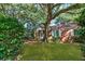 Beautifully landscaped front yard showcasing a charming brick home with mature trees and lawn at 624 Atlantic St, Mount Pleasant, SC 29464