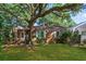 Lovely brick home featuring a big shade tree, green lawn, and charming curb appeal at 624 Atlantic St, Mount Pleasant, SC 29464
