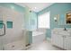 Bright bathroom features a glass shower door, soaking tub, and white vanity at 727 Sonny Boy Ln, Johns Island, SC 29455