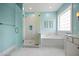 Bright bathroom features a glass shower door, soaking tub, and marble tile at 727 Sonny Boy Ln, Johns Island, SC 29455