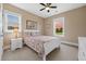Cozy bedroom with a white bed frame, floral bedding, and two windows at 727 Sonny Boy Ln, Johns Island, SC 29455