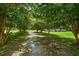 Long driveway lined with shade trees leading to the home's entrance at 727 Sonny Boy Ln, Johns Island, SC 29455