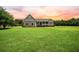 Charming home exterior with green lawn, inviting porch, and mature landscaping at 727 Sonny Boy Ln, Johns Island, SC 29455