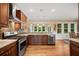 Updated kitchen with stainless steel appliances, tile backsplash, and a view of the dining area at 727 Sonny Boy Ln, Johns Island, SC 29455