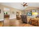 Bright living room featuring hardwood floors, a ceiling fan, vaulted ceilings, and a built-in shelving unit at 727 Sonny Boy Ln, Johns Island, SC 29455
