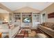 Bright and airy living room featuring hardwood floors and custom built-in shelving for storage and display at 727 Sonny Boy Ln, Johns Island, SC 29455