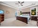 Spacious main bedroom features trey ceilings, bedside tables, and en suite bathroom at 727 Sonny Boy Ln, Johns Island, SC 29455