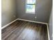 Small bedroom features wood-look flooring, neutral walls and a window at 7713 Suzanne Dr, North Charleston, SC 29418