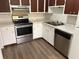 Kitchen featuring stainless steel appliances, white cabinets, and marble-look countertops at 7713 Suzanne Dr, North Charleston, SC 29418