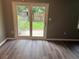 Living room features wood-look flooring and sliding glass doors leading to the backyard at 7713 Suzanne Dr, North Charleston, SC 29418