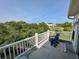 Tranquil balcony view of community homes, with lush trees surrounding the backyard at 81 Sandbar Ln # 28, Folly Beach, SC 29439