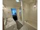 Bright bathroom featuring a tiled shower with a glass door and a marble countertop vanity at 81 Sandbar Ln # 28, Folly Beach, SC 29439