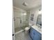Bathroom featuring a glass-enclosed shower, toilet, modern vanity, and stylish gray tile floor at 81 Sandbar Ln # 28, Folly Beach, SC 29439